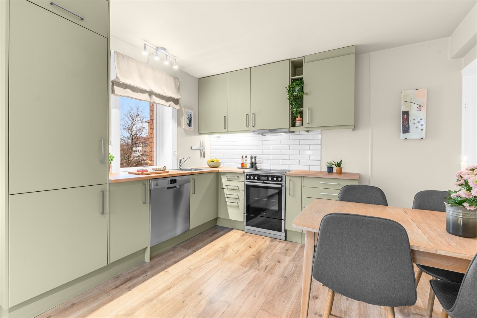 Kjøkkenet er utstyrt med en pen IKEA-innredning med glatte fronter og heltre benkeplate med nedfelt kum i rustfritt stål. Galleribilde