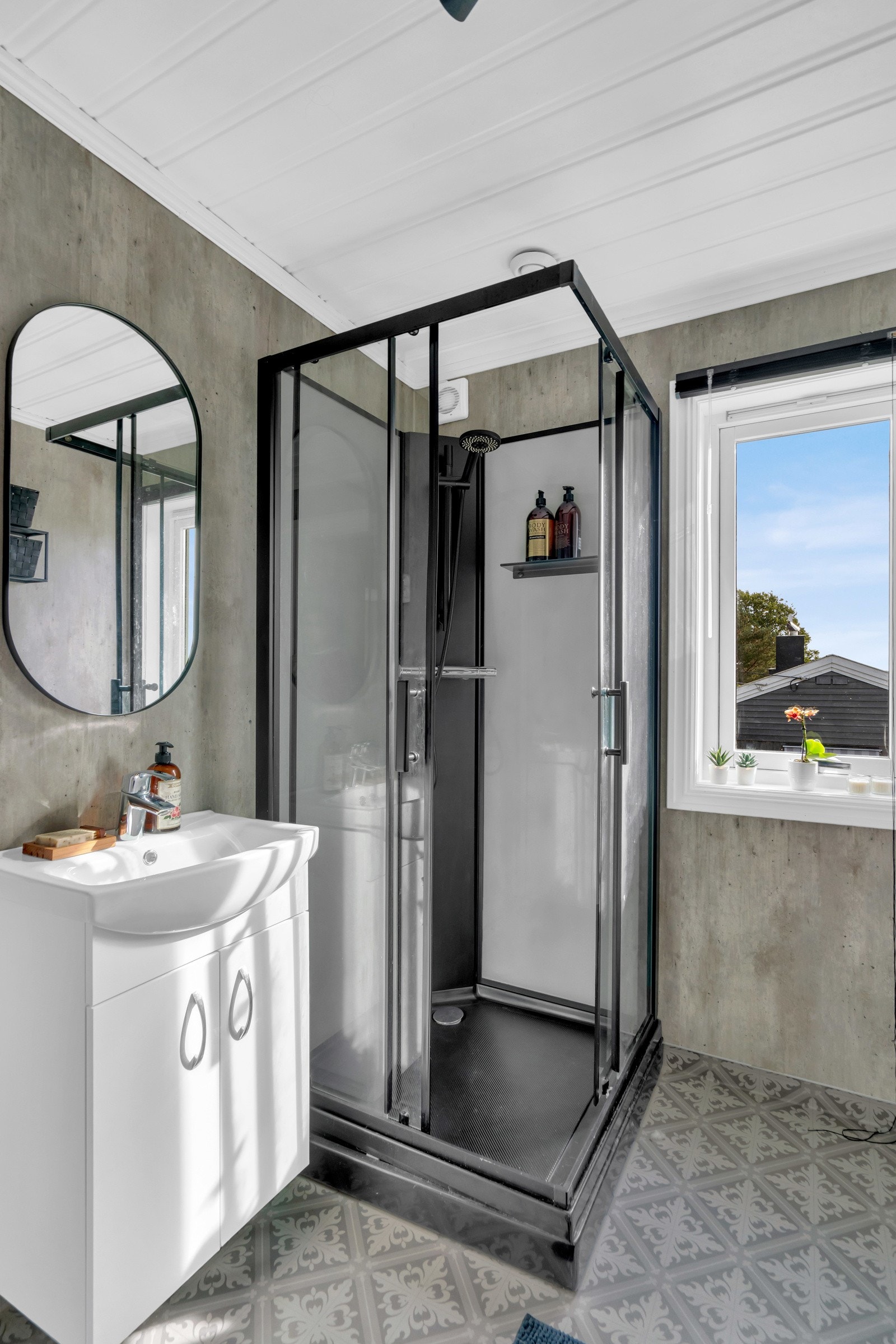 Badet er utstyrt med gulvvarme og et sort dusjkabinett. Galleribilde