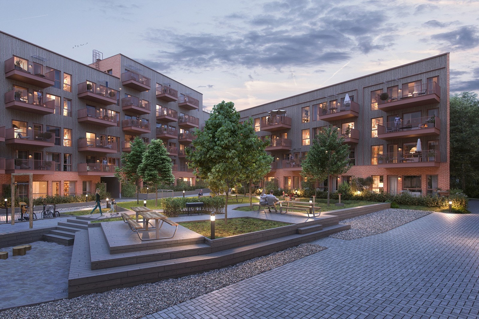 Vollebekk Stasjon har stort og luftig gårdsrom med grøntarealer, sittegrupper og område for lek. Galleribilde