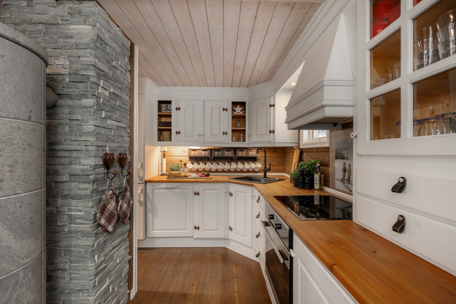 Kjøkkeninnredningen er fra 2012 med hvite, profilerte fronter i heltre og heltre benkeplate med kjøkkenkum. Galleribilde