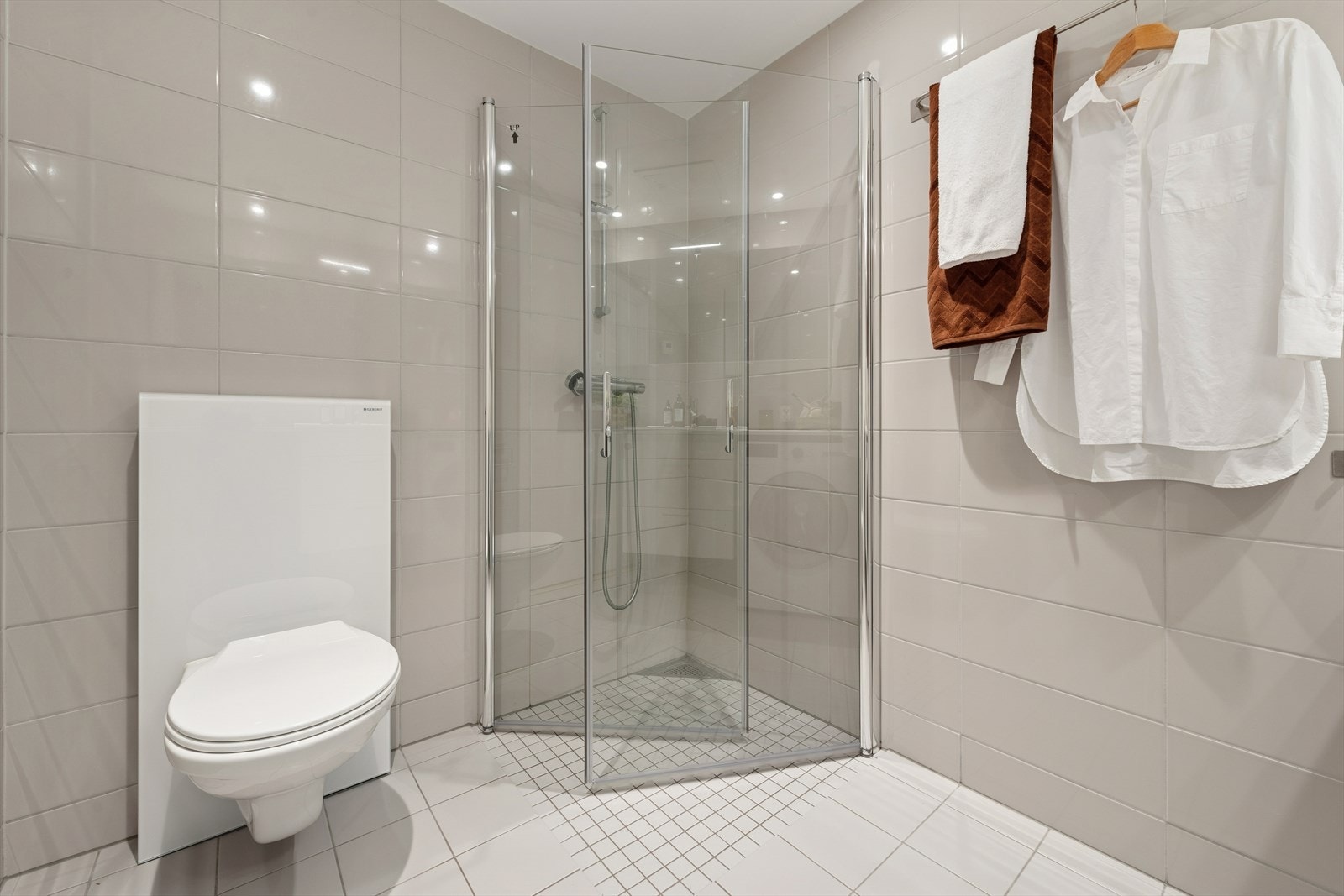 Badet er utstyrt med toalett, dusjhjørne og baderomsinnredning. Galleribilde