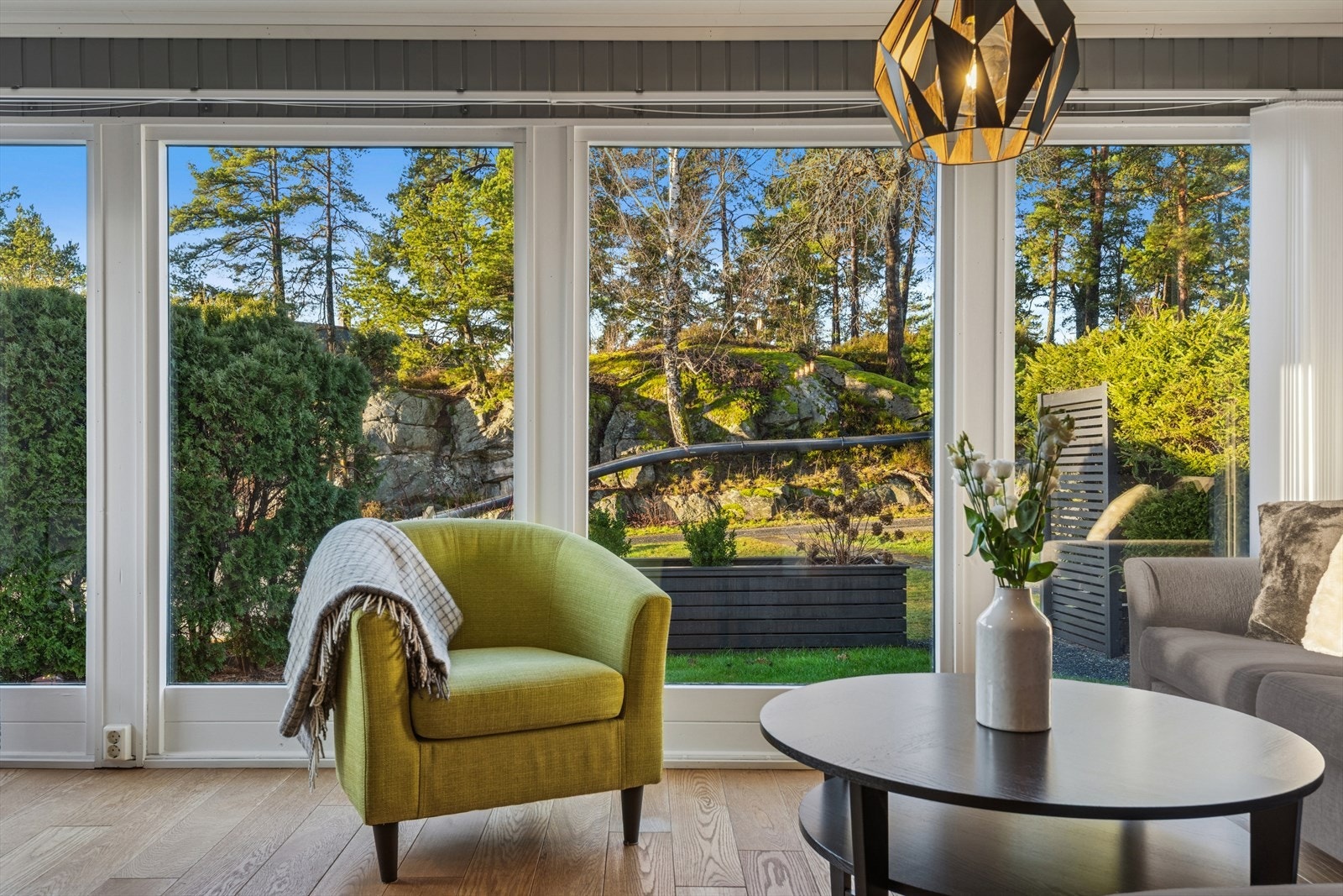 Store vindusflater i stuen gir utsyn mot grøntområde og slipper inn rikelig med dagslys. Galleribilde