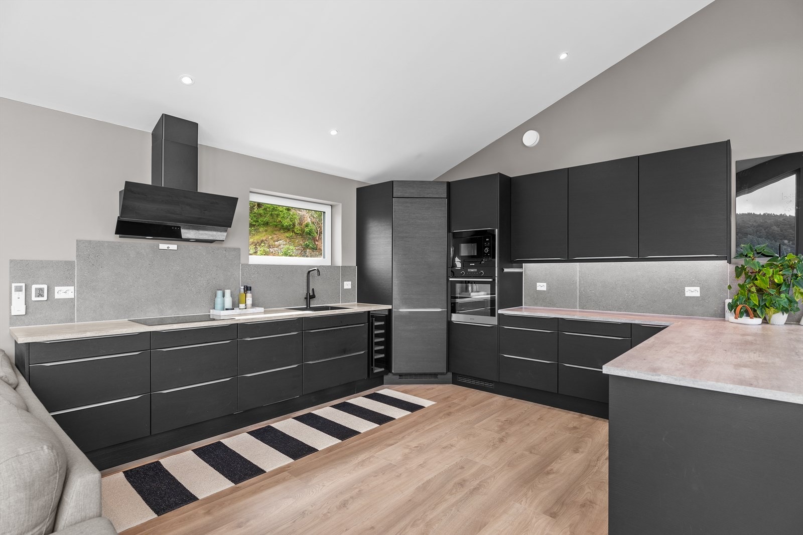 Kjøkken fra Sørlandskjøkken med glatte fronter og benkeplater i laminat. Galleribilde