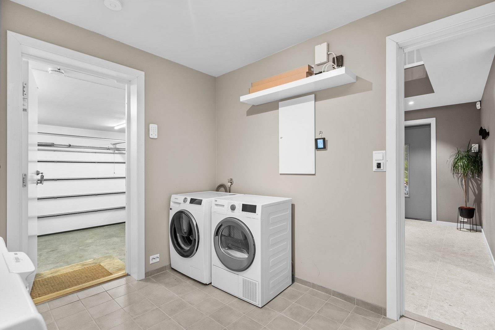 Vaskerom med god plass til både vask og oppbevaring. Egen inngang fra garasjen Galleribilde