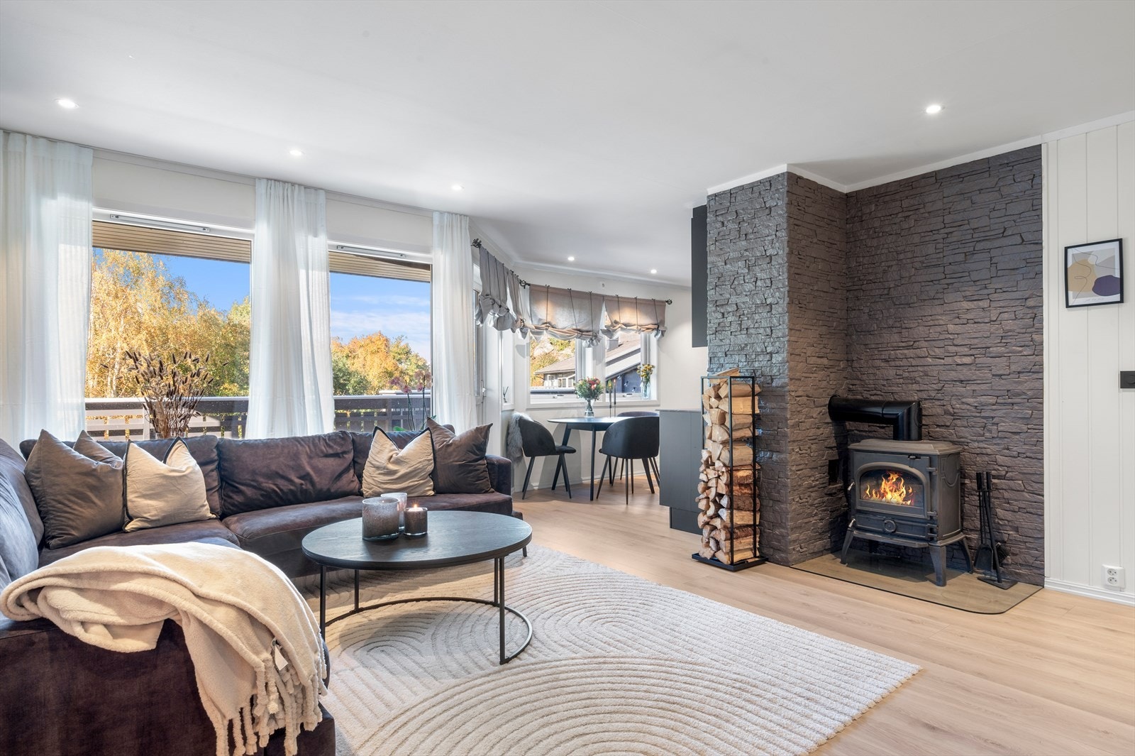 Stemningsfull og varmende vedovn som er sentralt plassert i rommet. Galleribilde