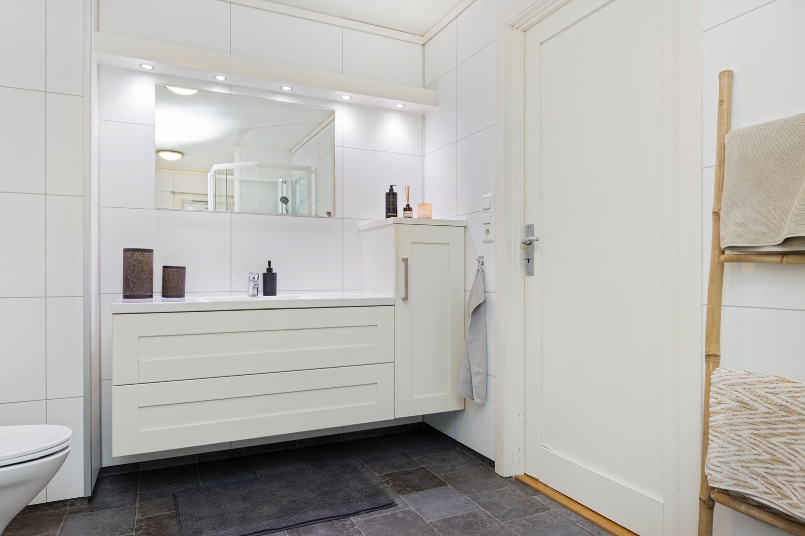 Også her finner vi en lys baderomsinnredning med servant og underskuffer og sideskap. Galleribilde