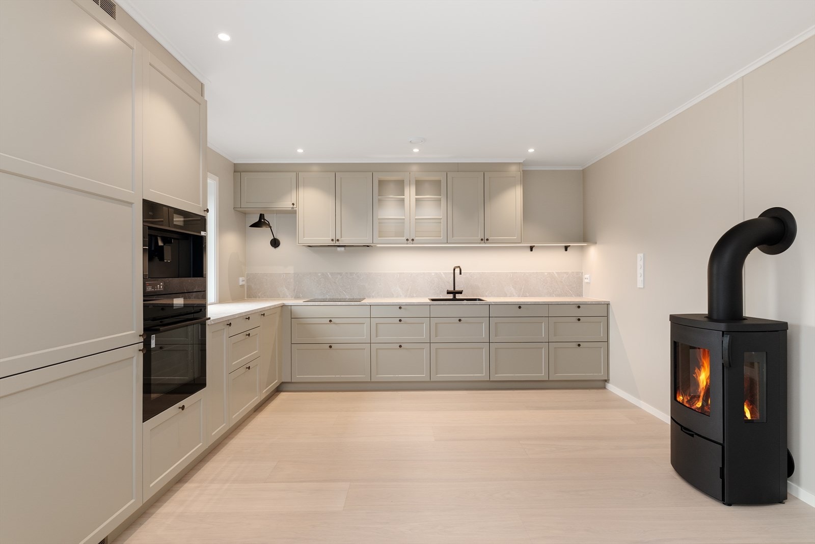 Kjøkkendelen har en delikat og påkostet innredning fra Drømmekjøkkenet/Ballingslöv type Gastro med profilerte fronter og noe glasskap, laminat benkeplate og beskyttelse over deler av kjøkkenbenk. Galleribilde