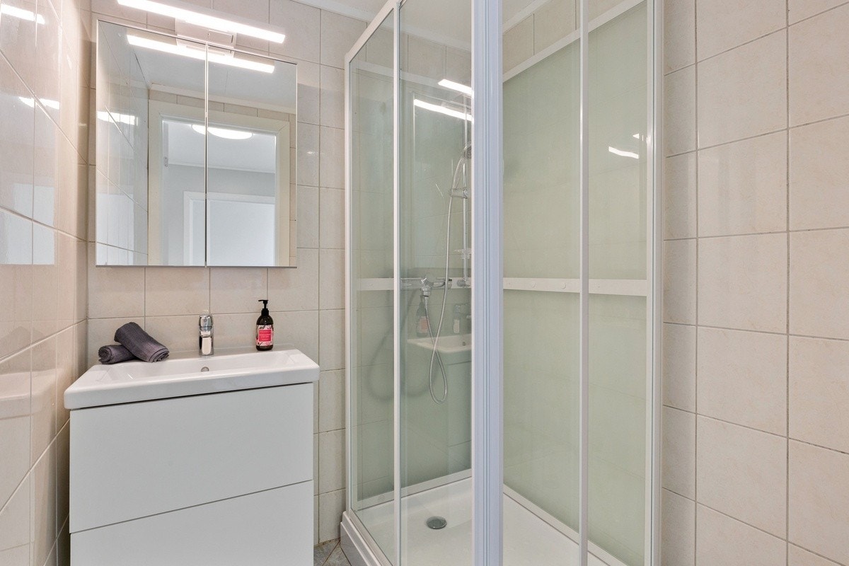 Leilighetens bad - med baderomsinnredning og dusjkabinett Galleribilde
