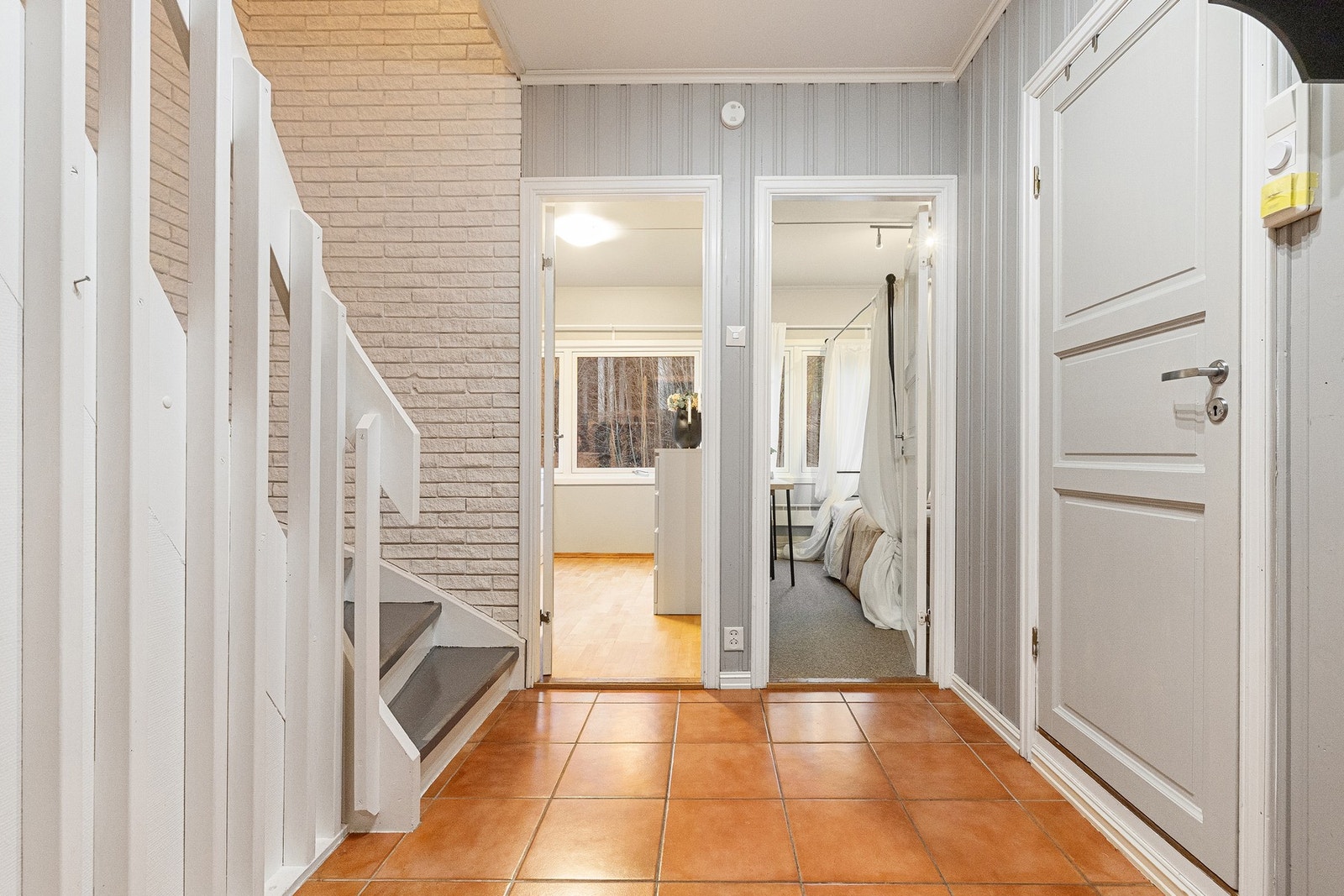 Entréen/gangen har flislagt gulv som er både slitesterkt og praktisk i hverdagen, og veggene er utført med malt panel som gir et pent og ryddig uttrykk. Galleribilde