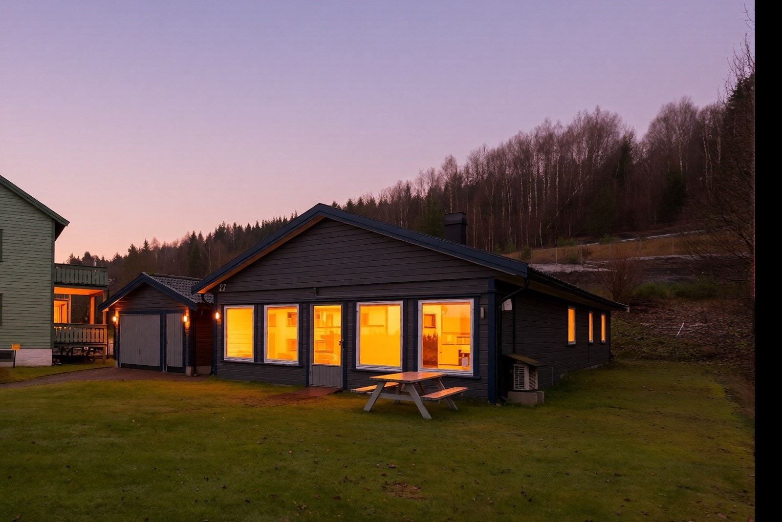 Boligen ligger på en tilnærmet flat tomt med pene og ryddige uteområder. Galleribilde