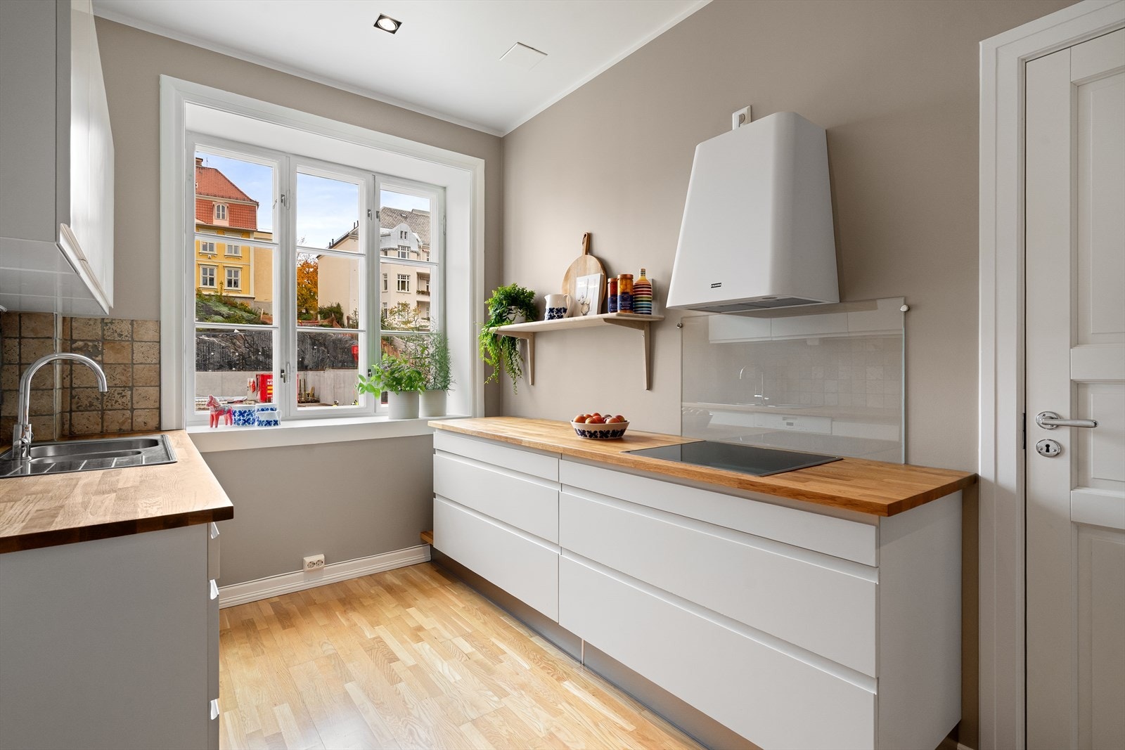 Pent kjøkken med Franke ventilator (2025), Electrolux stekeovn og Miele oppvaskmaskin (2024), samt Norrgavel-hylle fra 2025. Galleribilde