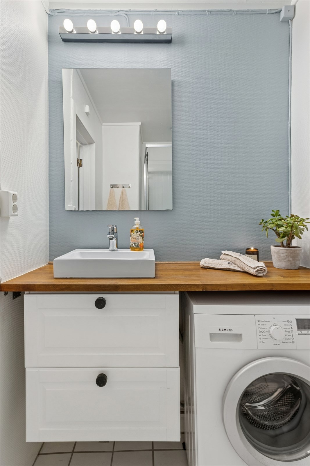 Det er satt inn plassbygget benkeplate på baderommet som har plass til vaskemaskin under. Galleribilde