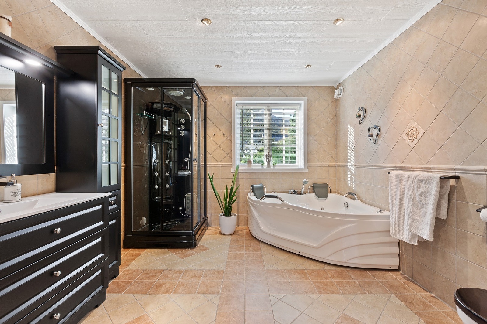 Romslig, flislagt bad med behagelig varme i gulv. Galleribilde