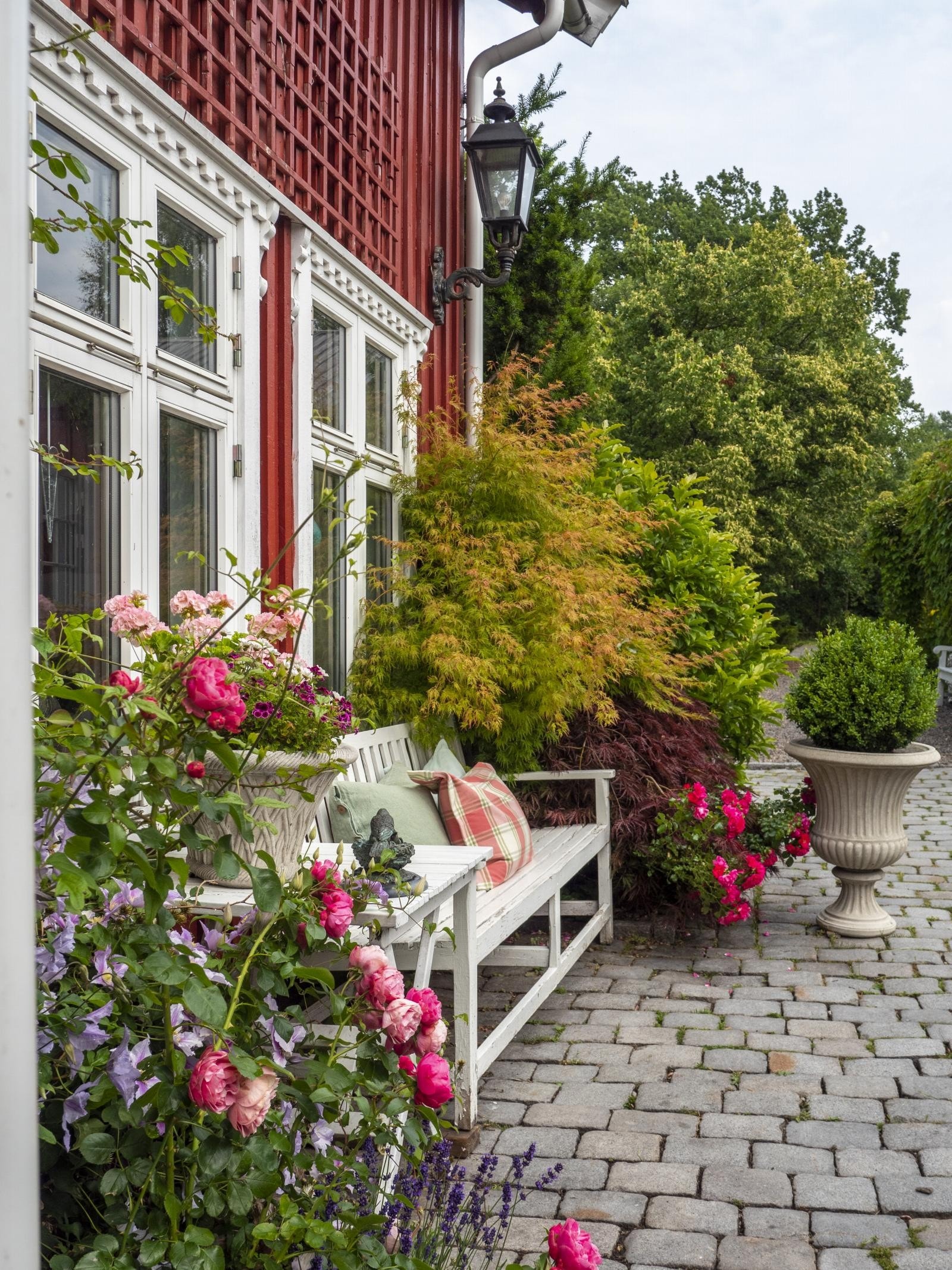 Utenfor inngangen og hagestuen er det lagt brostein. Galleribilde