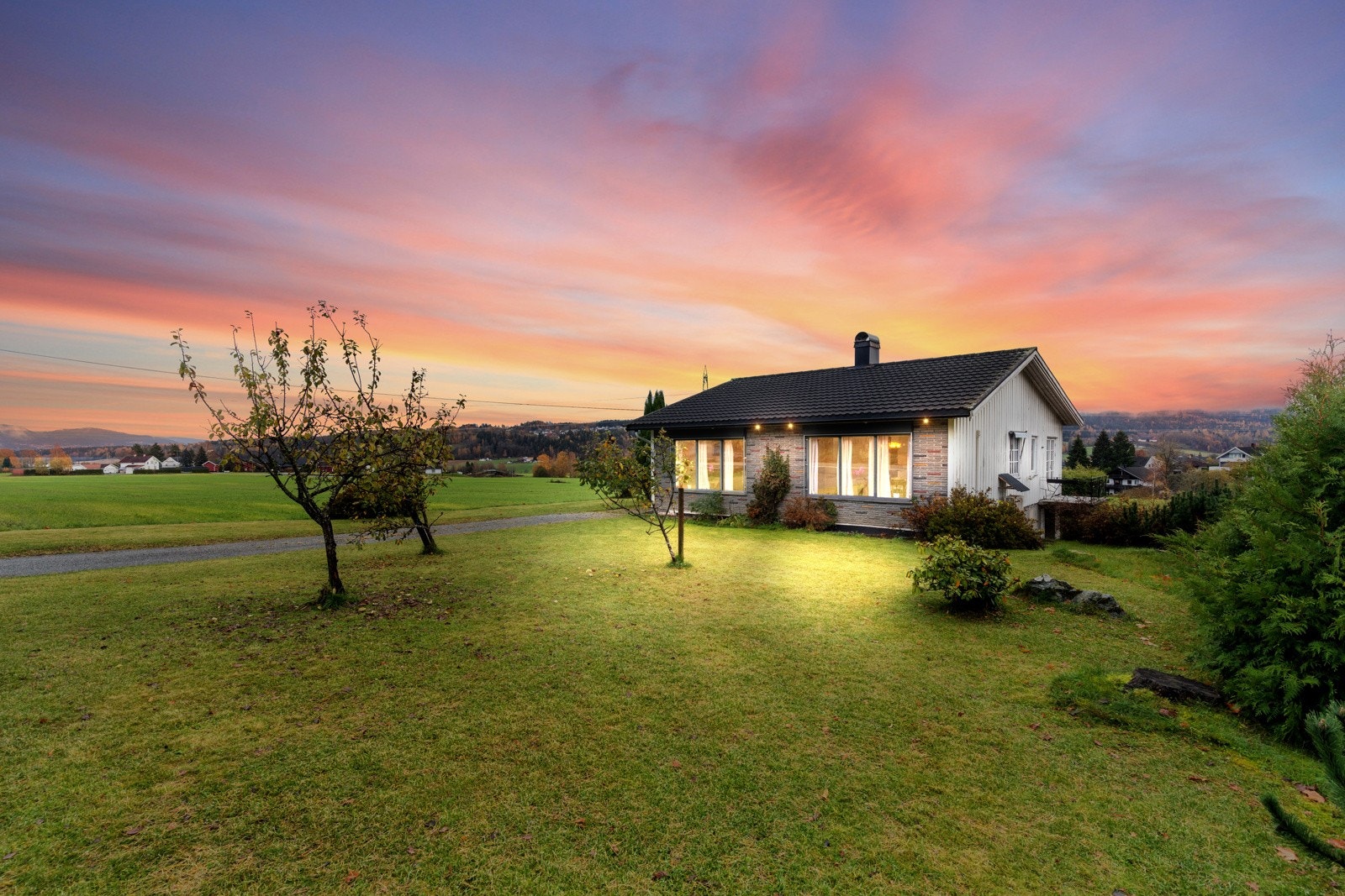 Boligen har en stor og solrik tomt på 1362 kvm. (illustrert kveldsbilde) Galleribilde