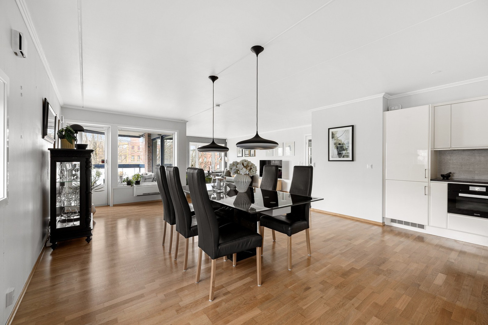 Det er god plass til et stort spisebord mellom kjøkkenet og stuen Galleribilde