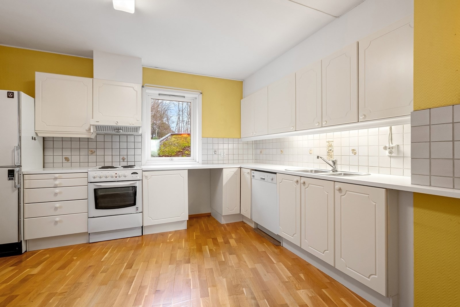 Kjøkkenløsning fra byggeår med Frittstående oppvaskmaskin, stekeovn(montert komfyrvakt)og kjøleskap med frysedel Galleribilde