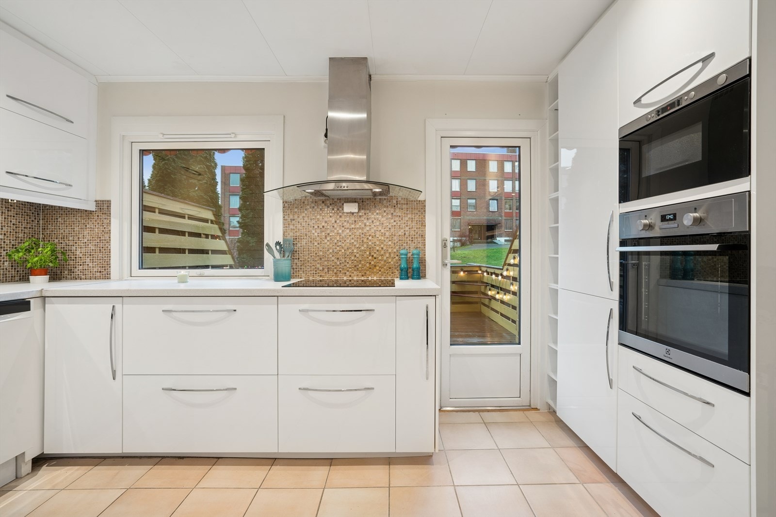 Kjøkkenet fra 2017 har en innredning med hvite, glatte fronter og en benkeplate i laminat med nedfelt vaskekum i stål. Galleribilde