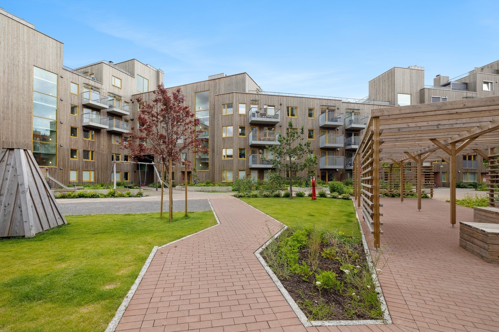 Attraktive Triaden shoppingsenter ligger i kort gangavstand fra leiligheten. Galleribilde