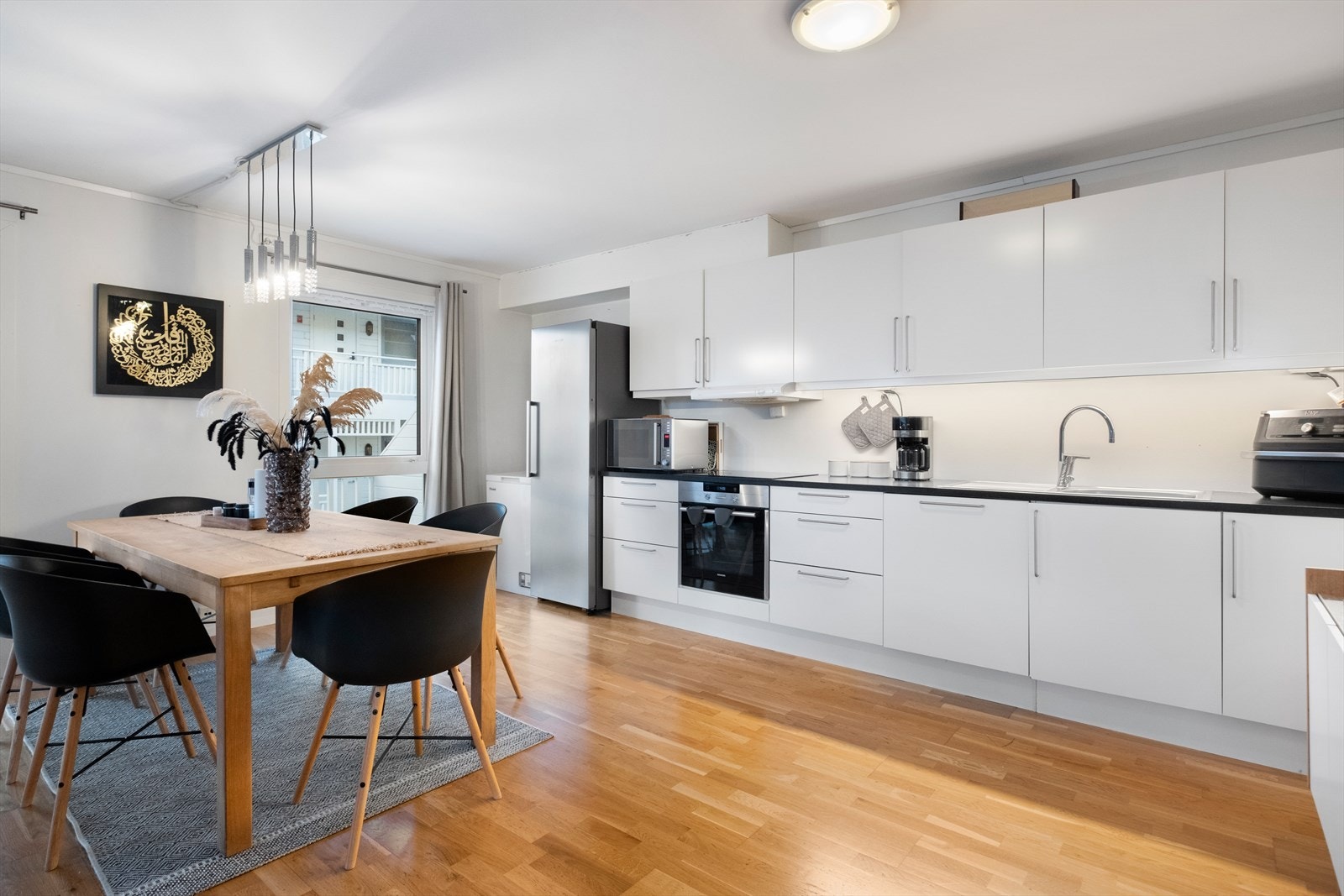 Pent og lys kjøkkeninnredning med glatte fronter Galleribilde