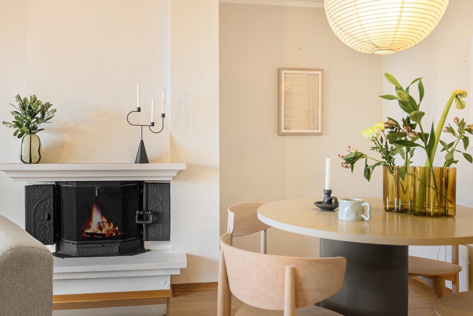 En åpen peis fungerer som et naturlig skille i rommet og er tilkoblet byggets sentrale pipe med innsats. Galleribilde