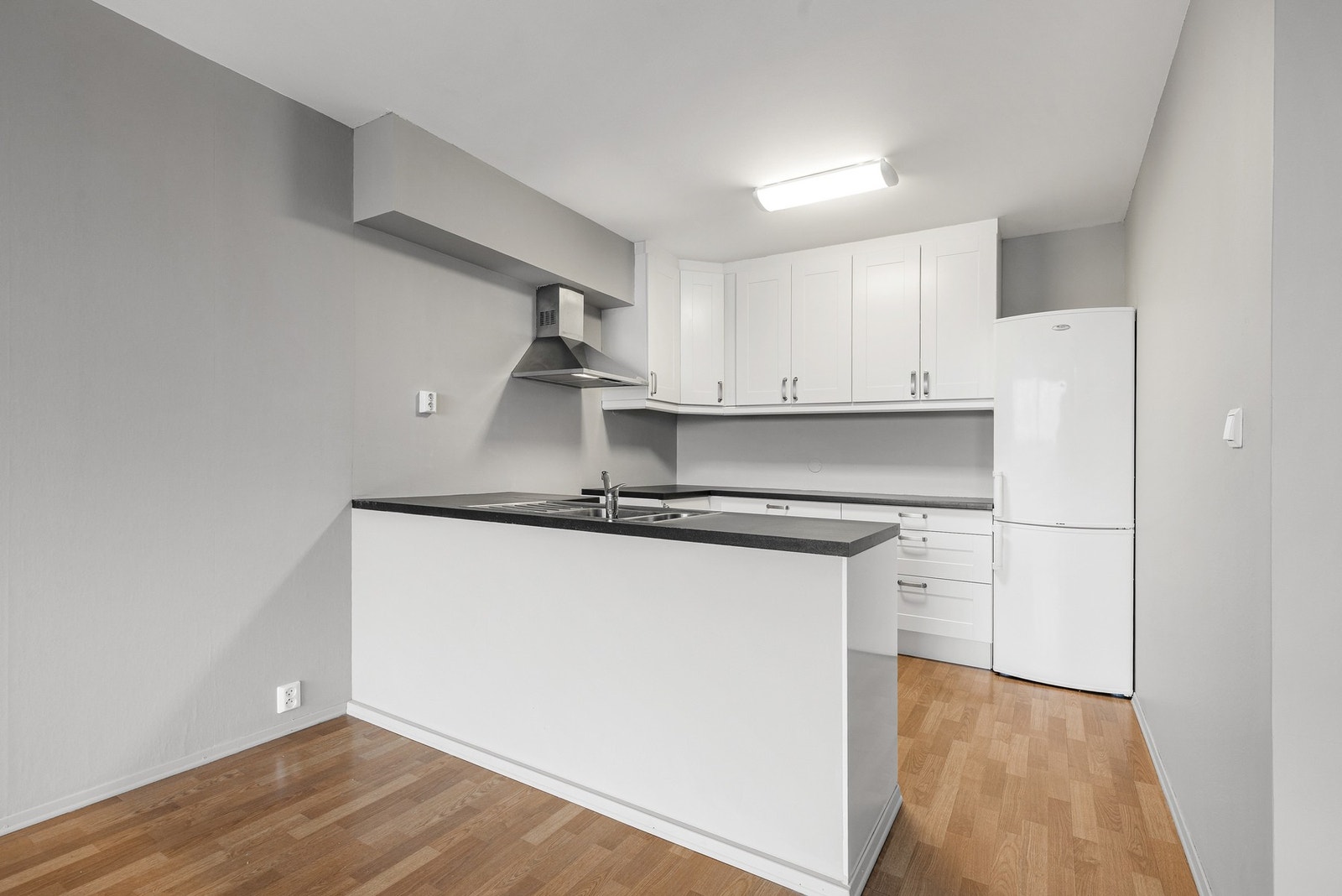 Ikea-kjøkkeninnredning fra 2012 med profilerte fronter og laminat benkeplate Galleribilde