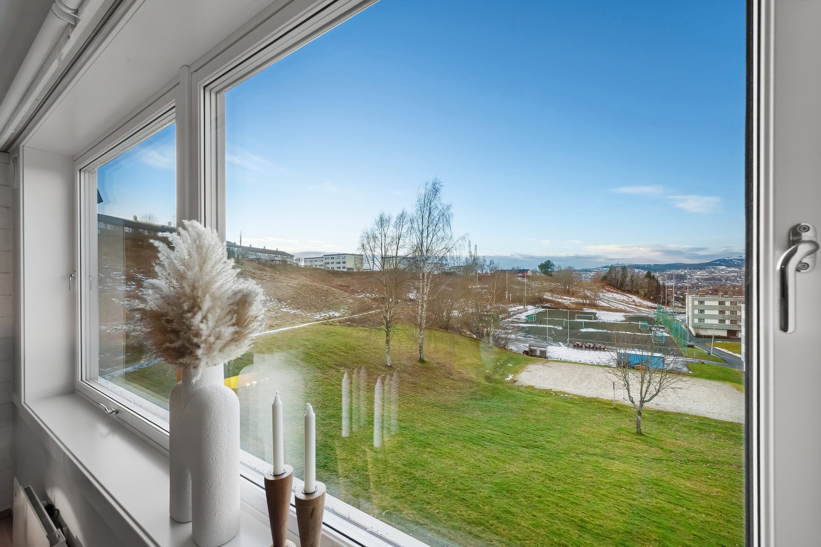 Fra stuen har man flott utsikt mot felles grøntarealer. Galleribilde