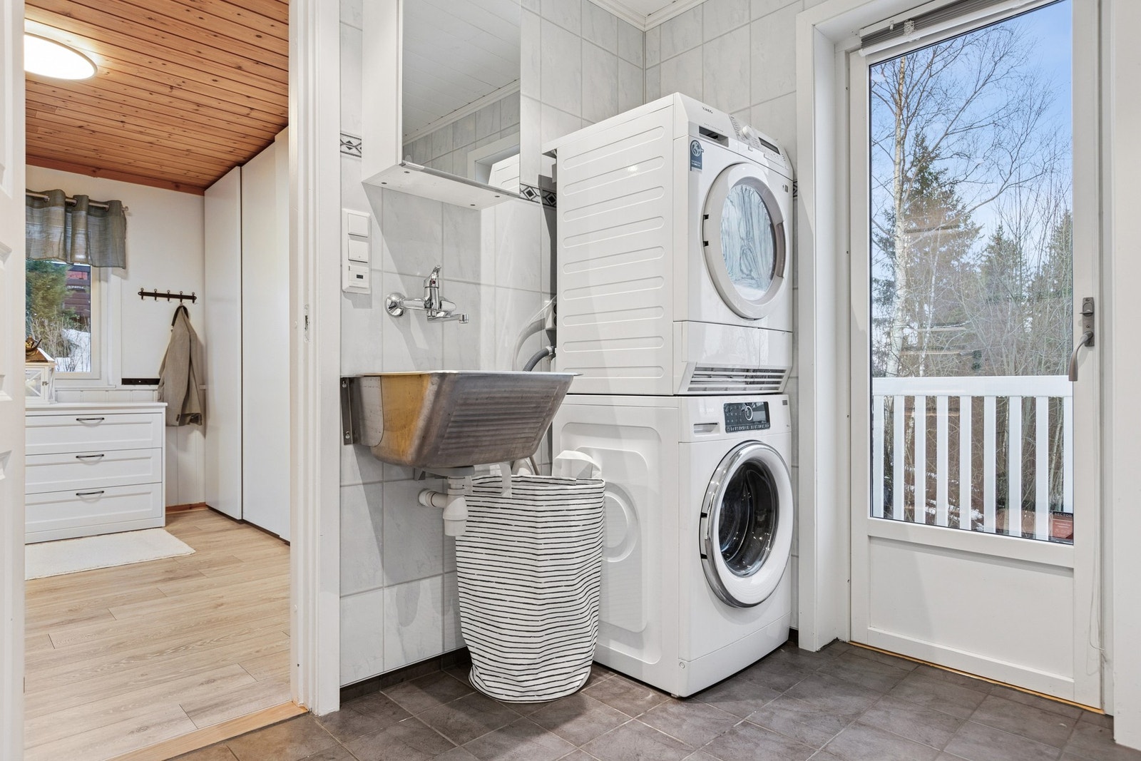 Badet i første etasje brukes også som vaskerom. Det er uttak til vaskemaskin og utslagsvask med vannkran i tilknytning til denne. Praktisk utgang til veranda. I tilknytning til badet ligger har man soverom. Galleribilde
