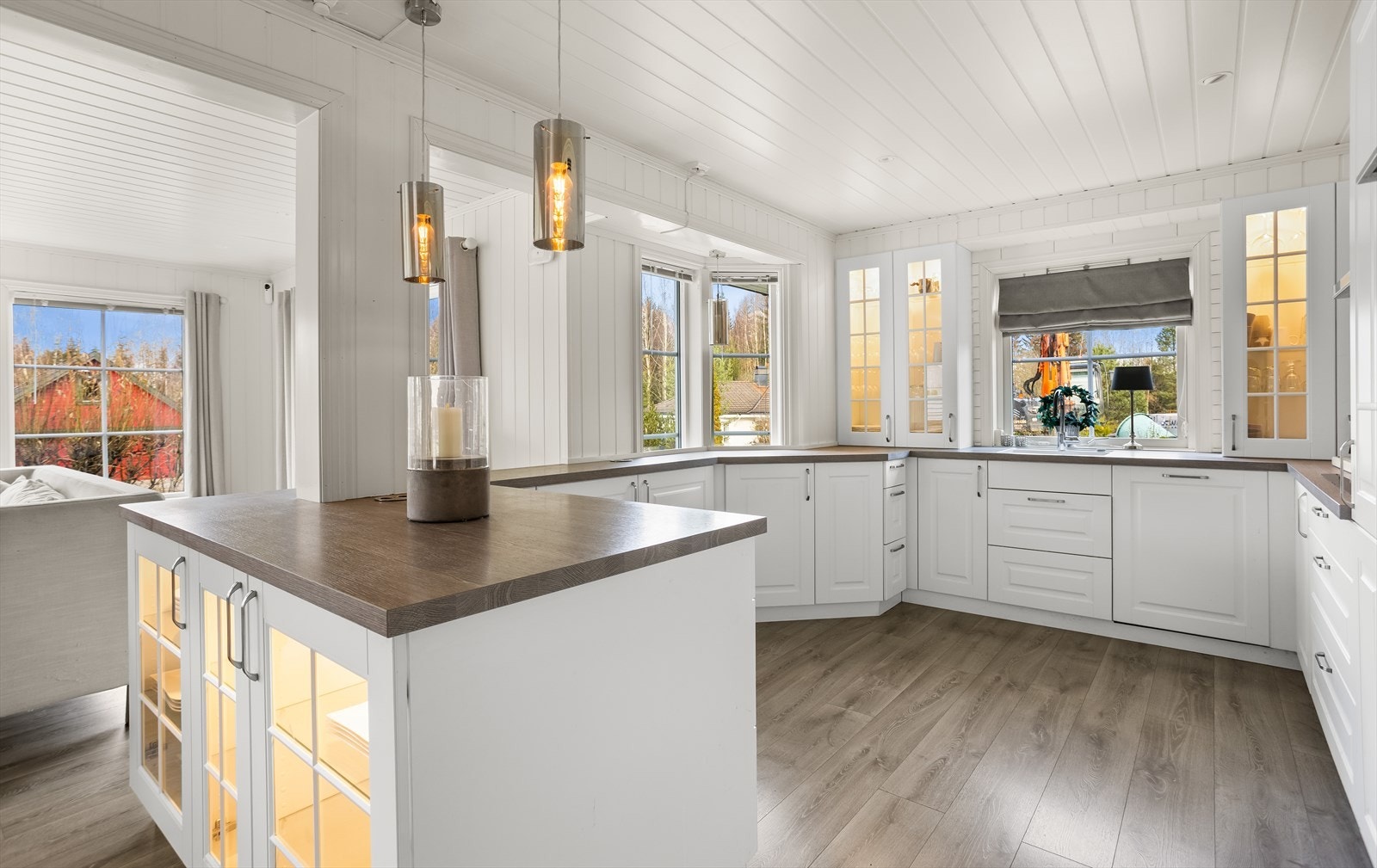 Innredningen har hvite, profilerte fronter og en mørk benkeplate i laminat. Galleribilde