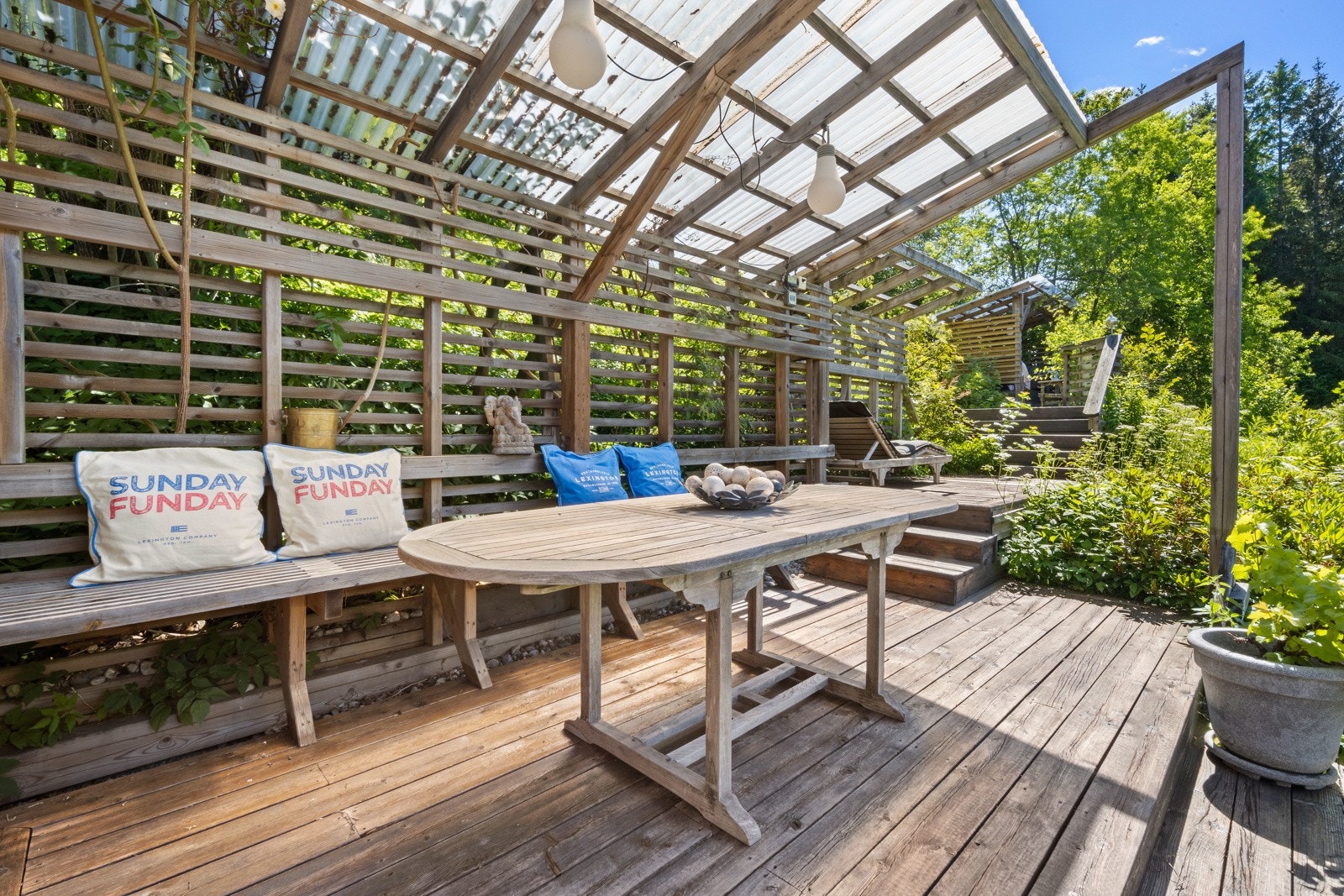 Veandaen går over flere nivåer og har to pergolaer. Her er det enkelt å skape ulike soner for møblering. Galleribilde