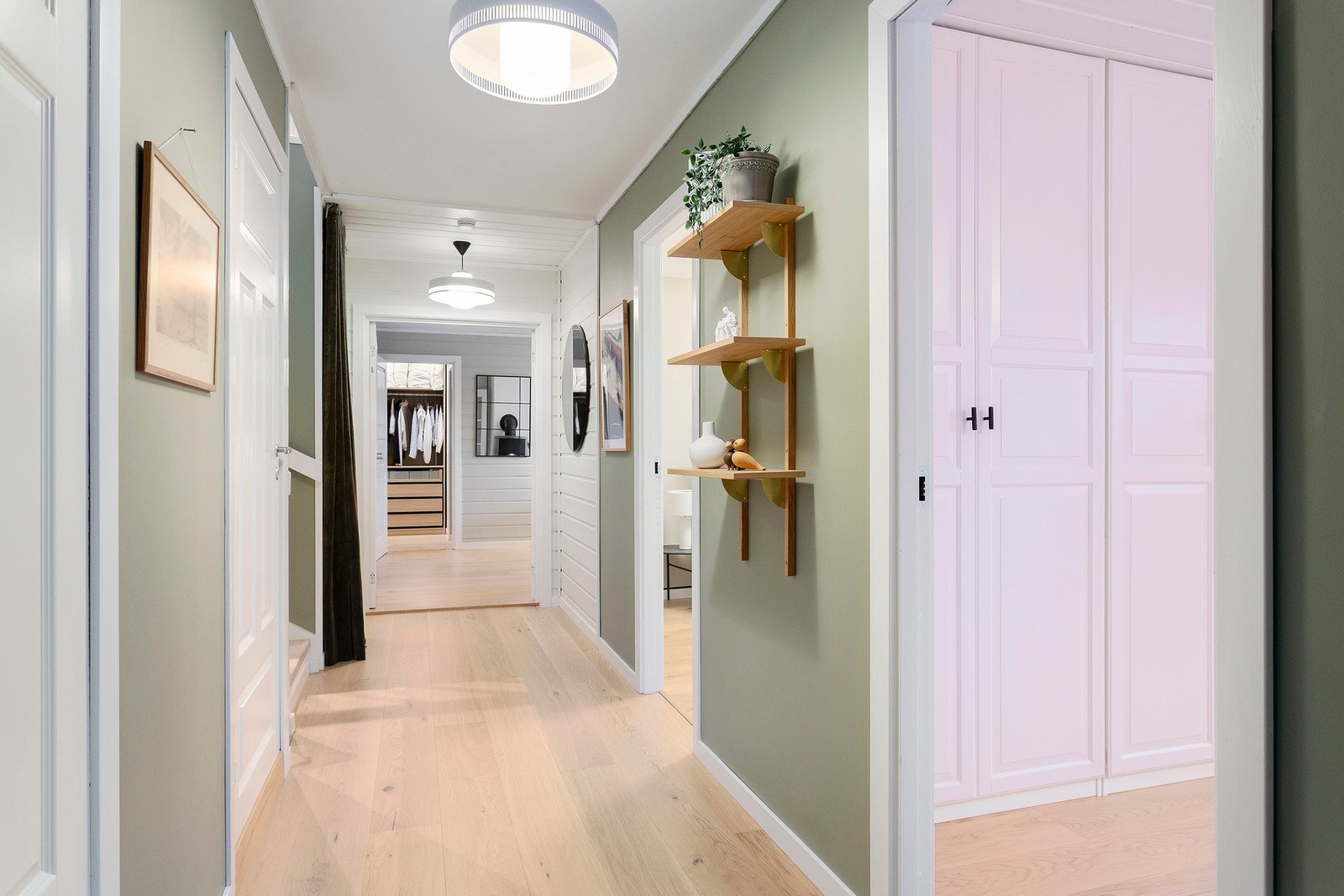 Soveromsgangen er malt i en moderne grønnfarge med stilig enstavsparkett på gulvet. Galleribilde