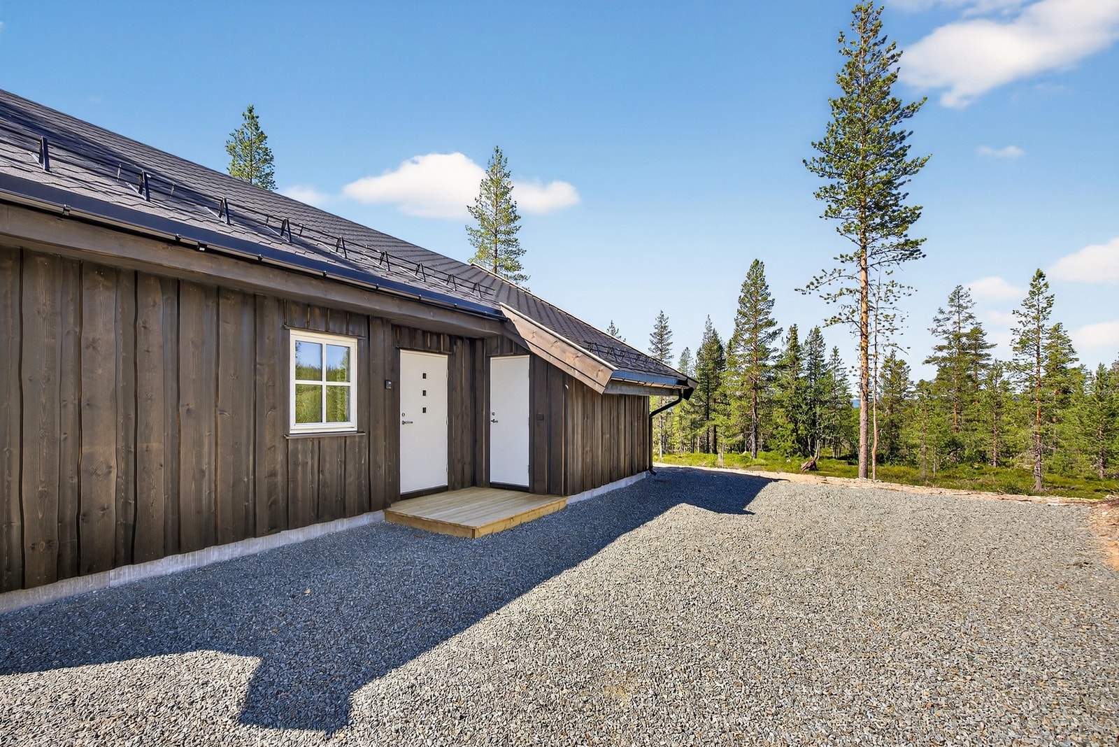 Det er bilvei frem til hytteveggen, og det er god plass til flere biler i gårdsplass. Bildet er ikke av selve hytta. Galleribilde