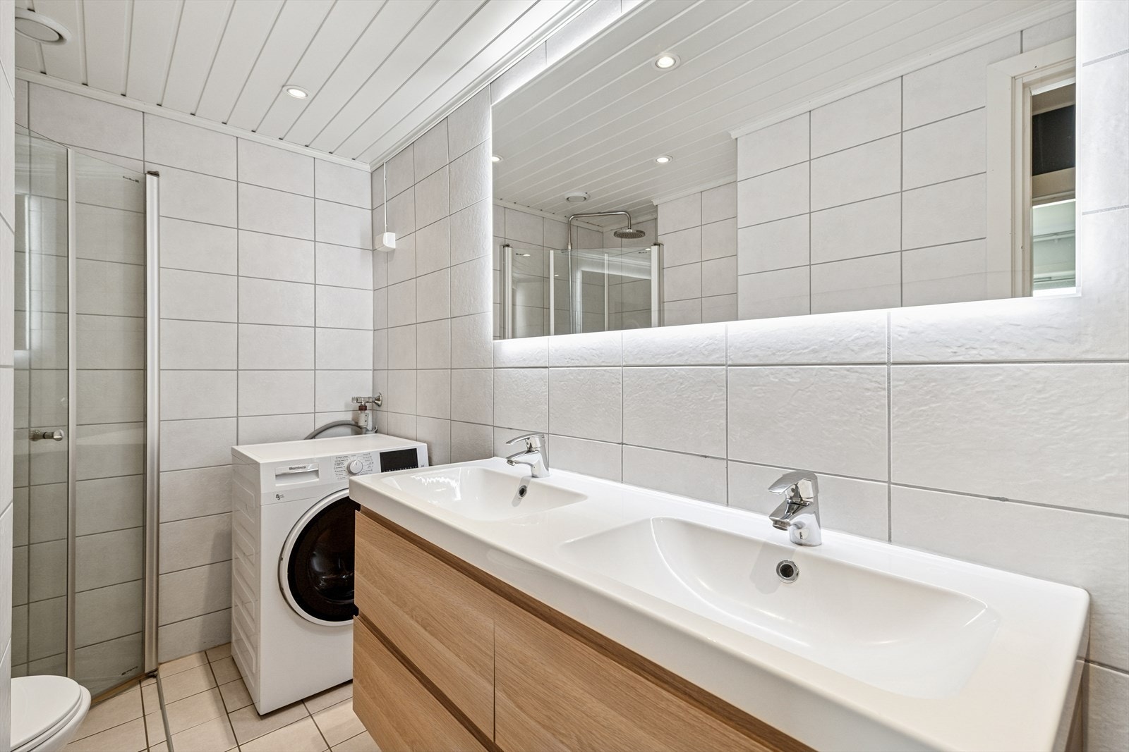 Leiligheten har et lyst og delikat fliselagt bad med varmekabler i gulv. Galleribilde