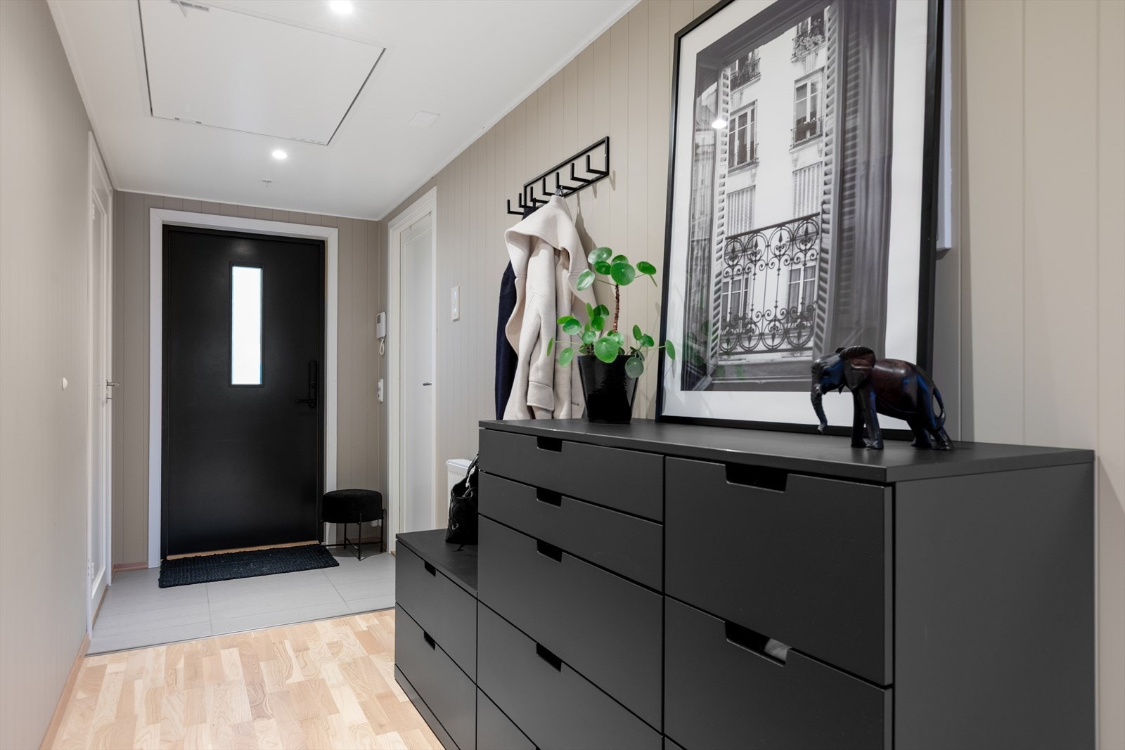 Romslig entré med flislagt gulv og plass til oppbevaringsmøbler. Galleribilde