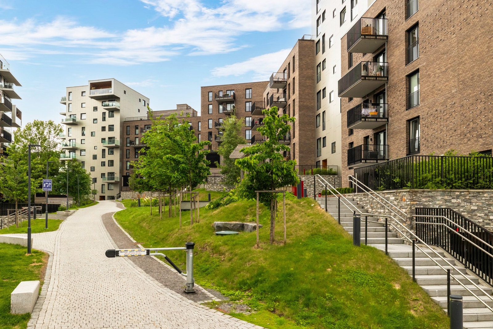Her er det en stor plen, felles grill, benker og lekeapparater. Galleribilde