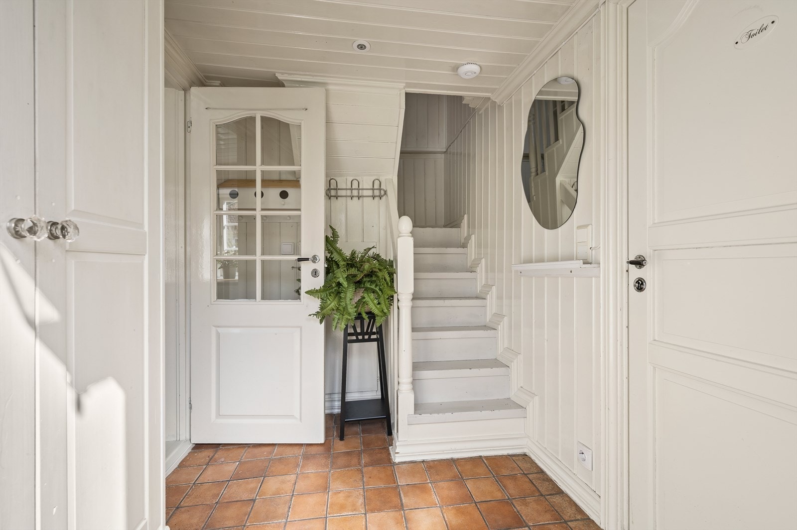 Inngangsparti med trapp opp til 2. etasje, samt tilkomst til bad, og kjøkken/stue. Galleribilde