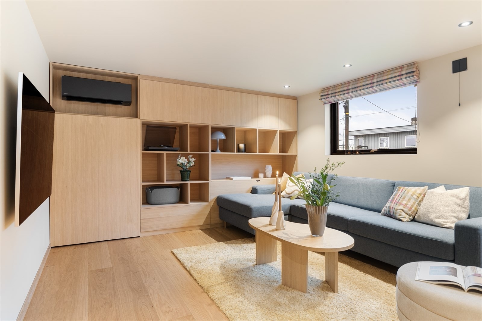 Innredet rom brukt som kjellerstue med plassbygget innredning i eikefiner med god oppbevaringsplass Galleribilde