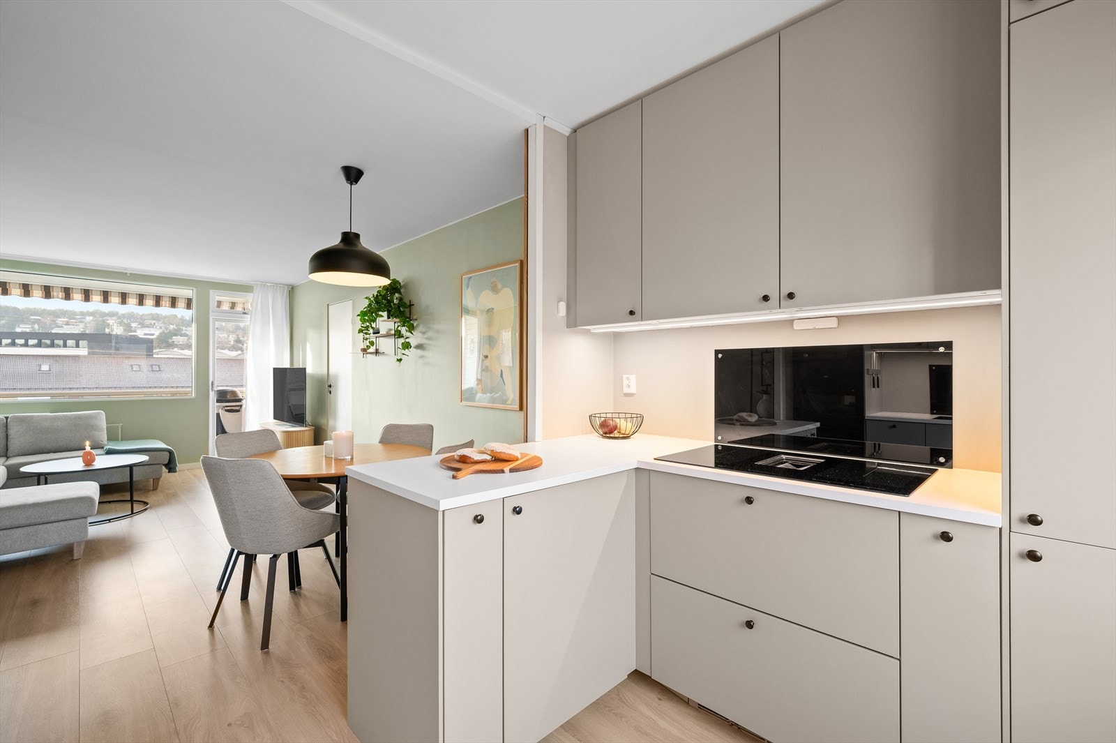 På grunn av den åpne løsningen mot stuen/spisestuen kan man enkelt ha god kontakt med gjestene mens man tilbereder et godt måltid. Galleribilde