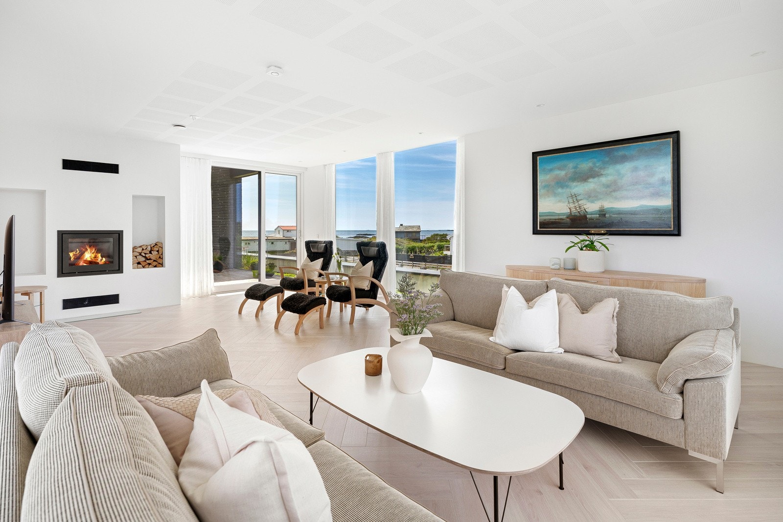 Den store stuen oppe har laminat i fiskebensmønster, listefri himling og lysmalte veggflater med én fondvegg i eikefiner. Galleribilde