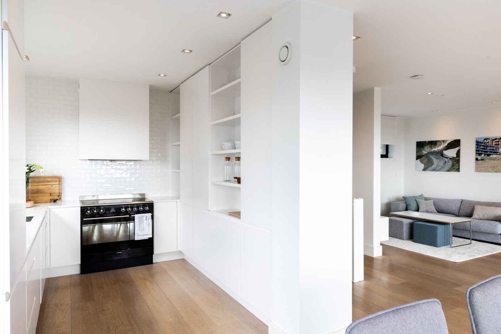 Kjøkkenet fremstår stilrent og funksjonelt med glatte, hvite fronter og benkeplate i slitesterk kompositt. Galleribilde