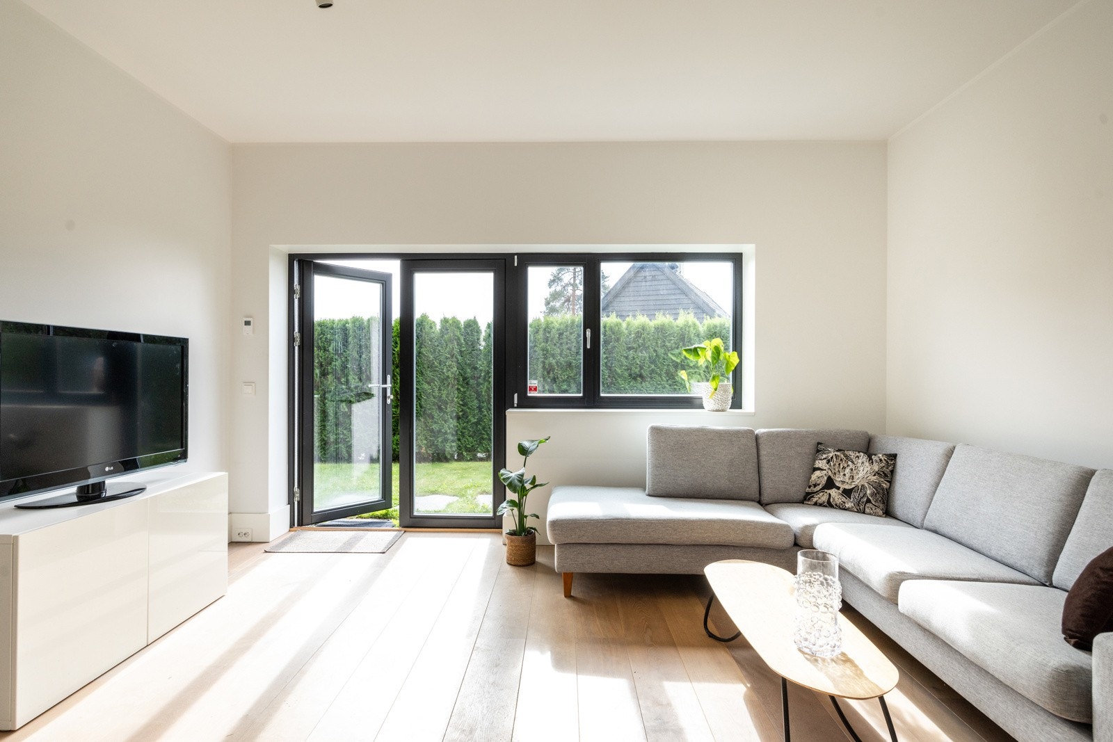 Hybeldelen har en lys og trivelig stue med åpen kjøkkenløsning. Store vindusflater og utgang til hage gir en luftig atmosfære og godt med naturlig lys. Galleribilde