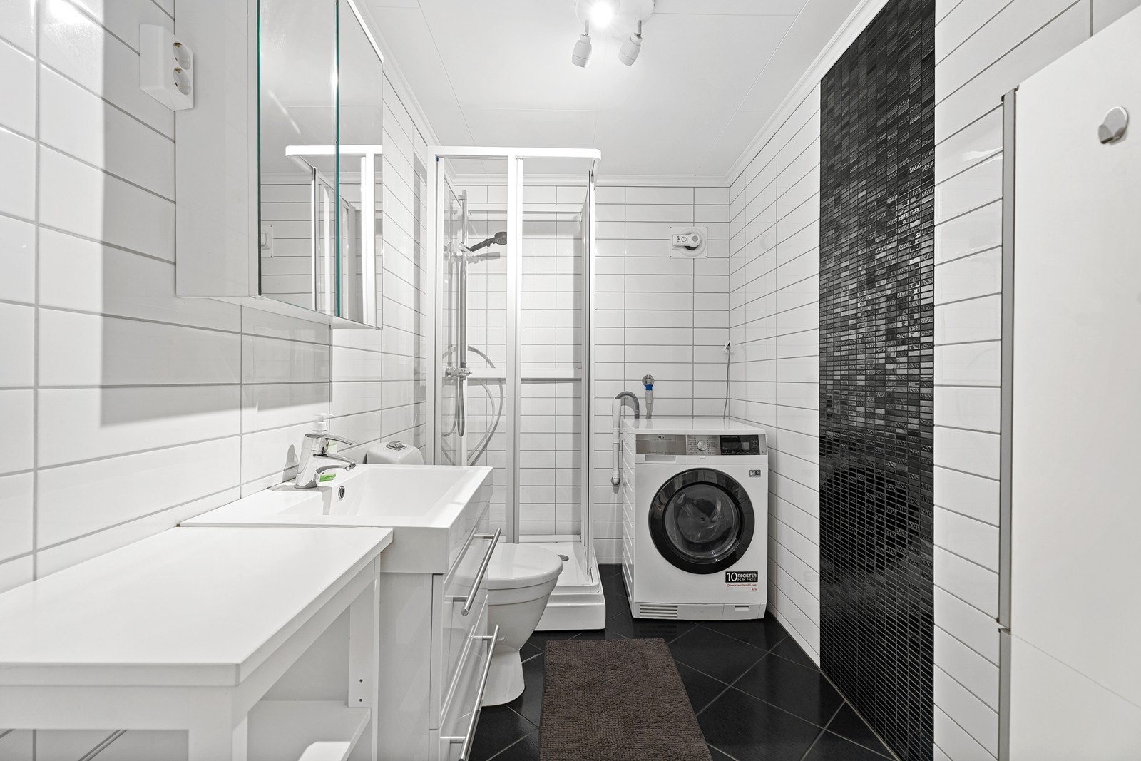 Badet er innredet med servant, toalett og dusjkabinett. Opplegg for vaskemaskin. Galleribilde