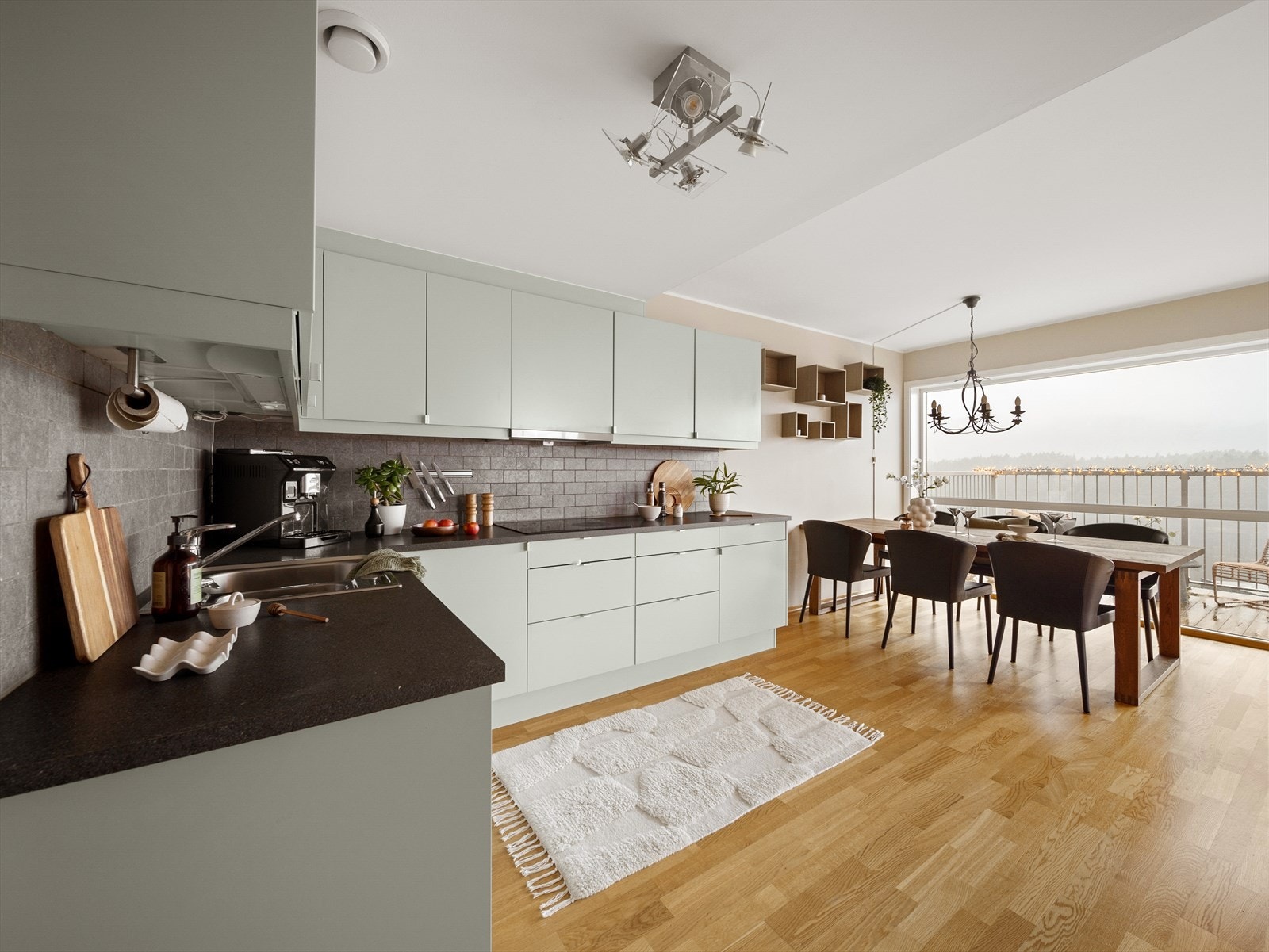 Moderne kjøkken som har slette fronter og en benkeplate av laminat med integrerte hvitevarer. Galleribilde