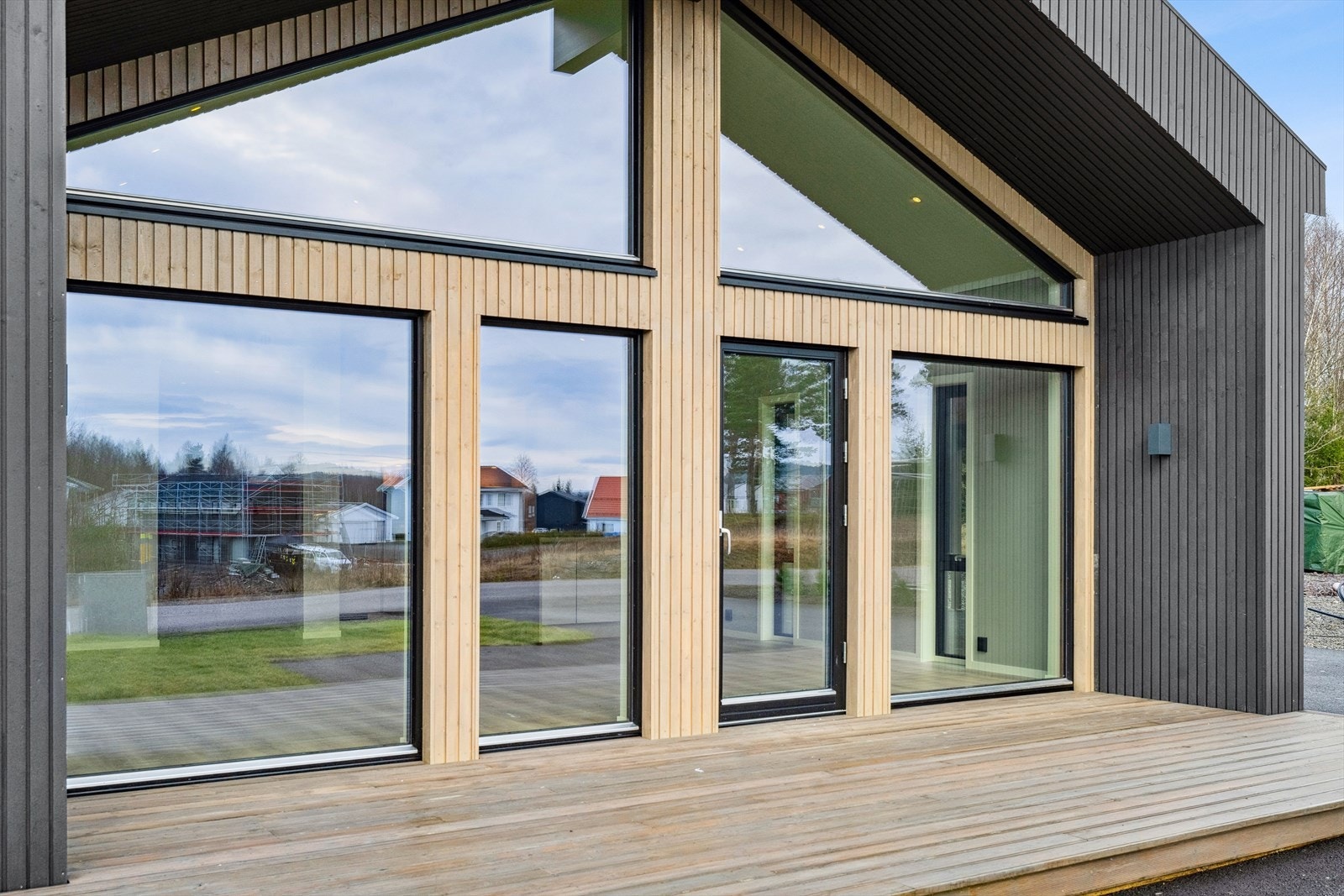 Stilig løsning med betydelig glass i veggen mellom stua og verandaen Galleribilde