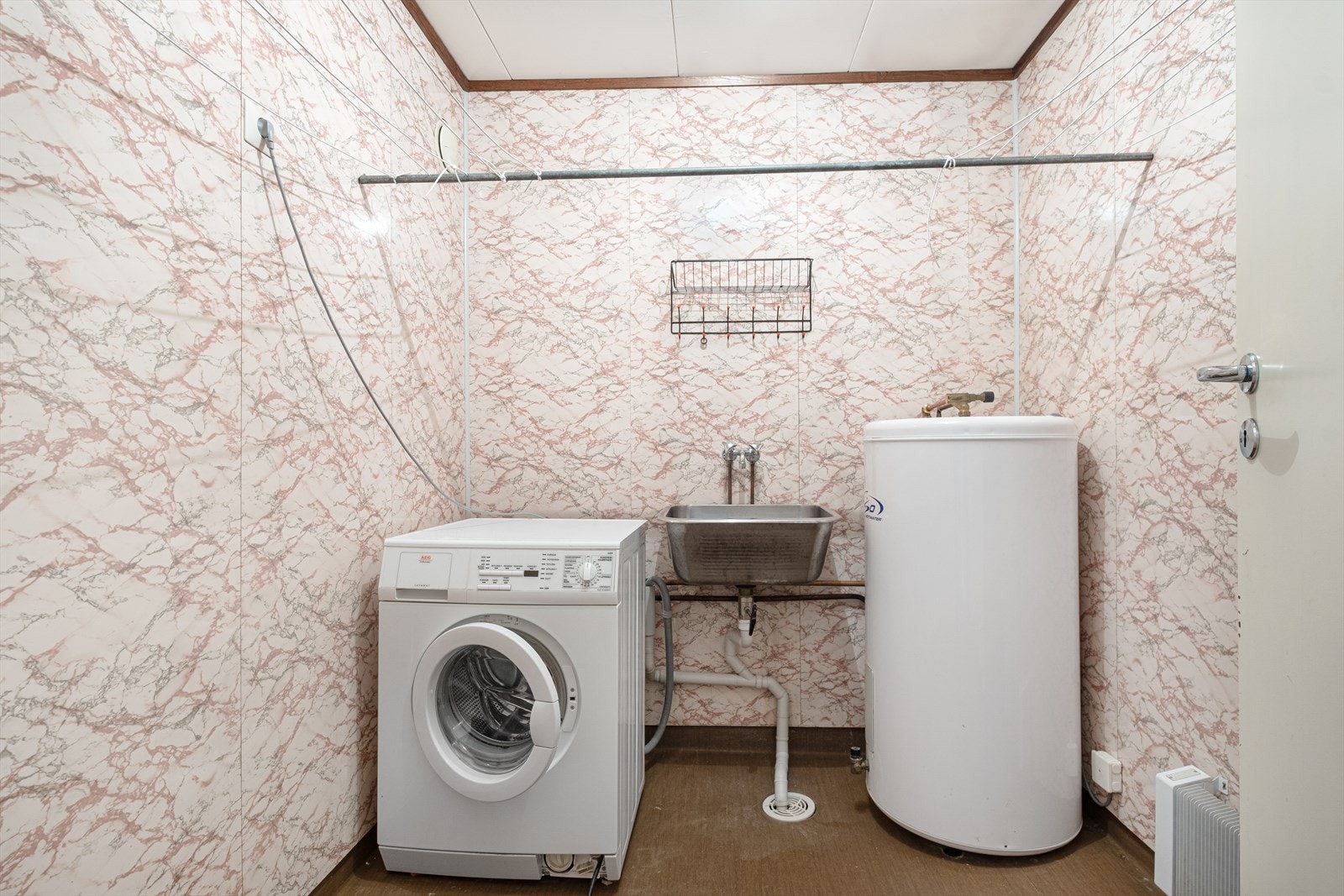 Vaskerom i underetasje med skyllekum, varmtvannsbereder og opplegg for vaskemaskin Galleribilde