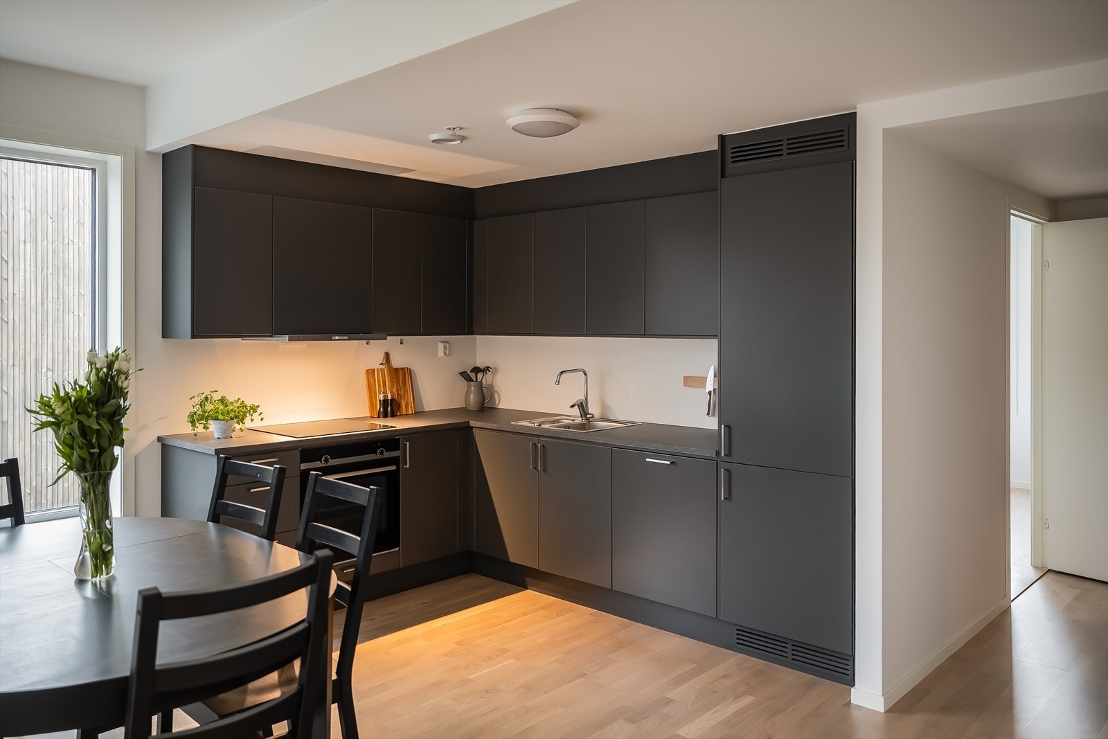 Lekkert og tidløst kjøkken fra byggeår. Her får du rikelig med benkeplass i både over- og underskap, samt alt av integrerte hvitevarer. Galleribilde