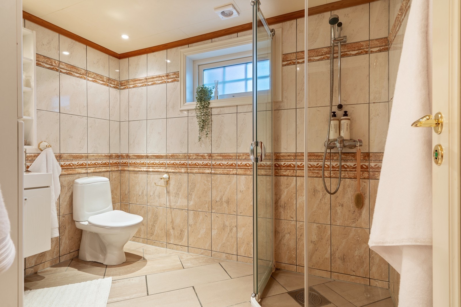 Badet fremstår lyst og delikat med fliser på både vegger og gulv samt varmekabler i gulvet. Galleribilde