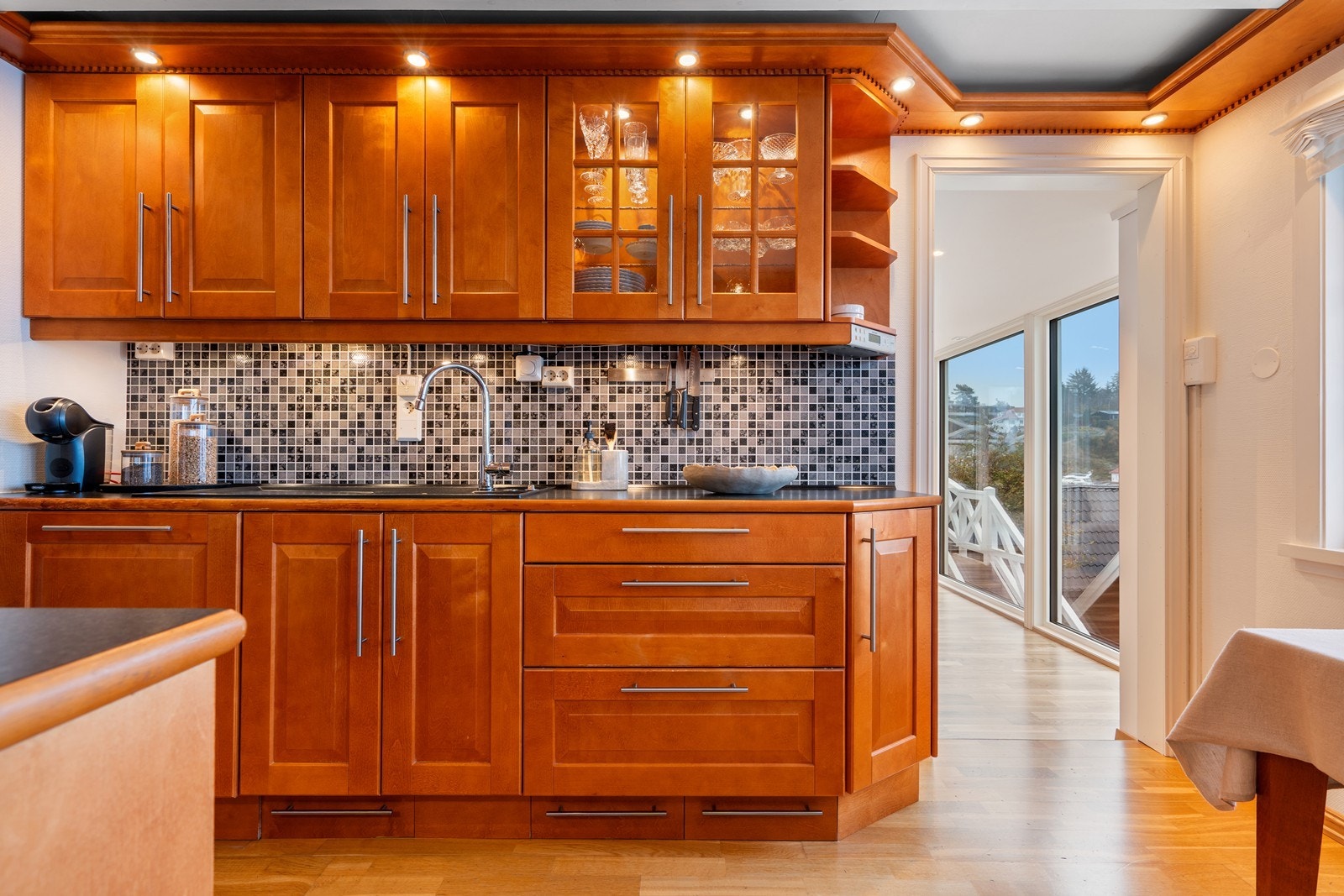 Kjøkkenet er opplyst med stilfulle integrerte spotter som gir et jevnt og behagelig lys. Galleribilde