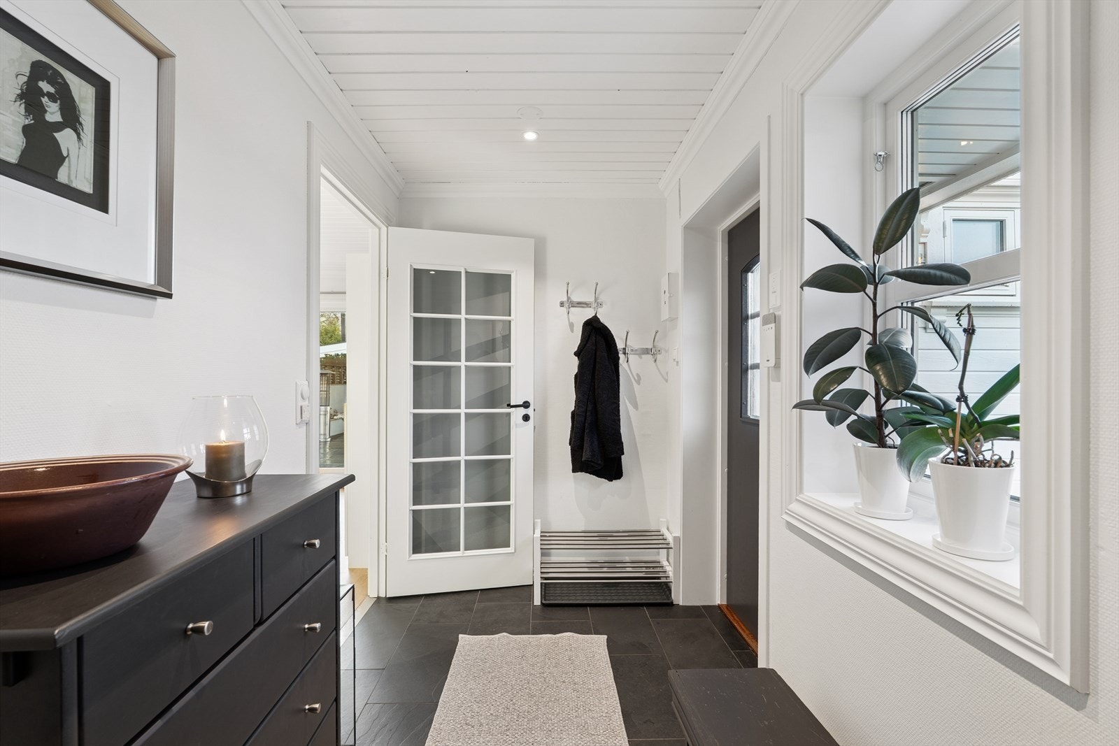 Entréen er lys og praktisk, med flislagt gulv og downlights i himlingen samt en delikat skyvedørsgarderobe Galleribilde