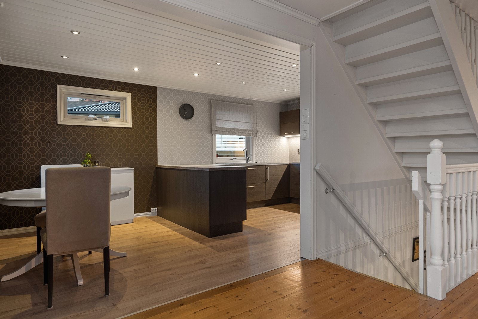 Åpen kjøkkenløsning med laminatgulv gir en praktisk og romslig spiseplass. Galleribilde